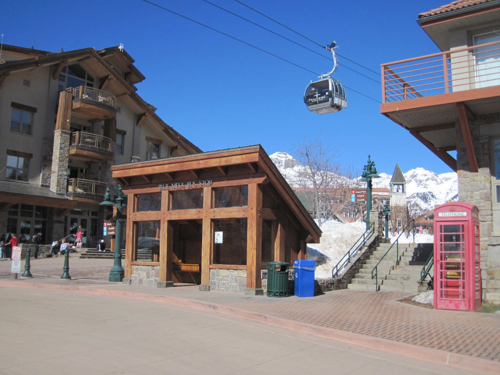 Telluride gondola cabin traveling above Blue Mesa Bus Stop in Telluride Mountain village