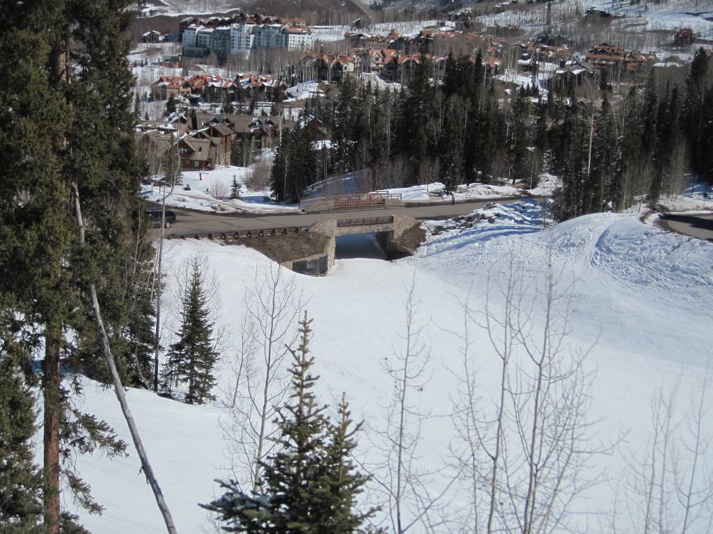 Looking down onto the Double Cabin ski trail at Telluride with stone bridge crossing above ski trail