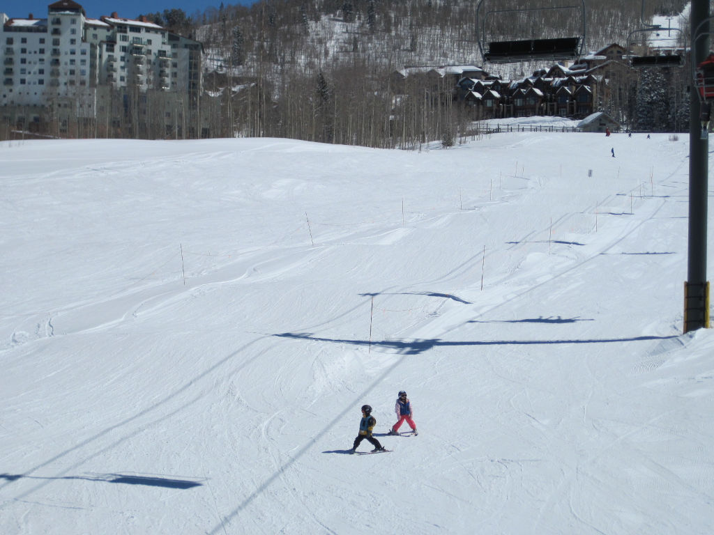 Two small kids skiing on beginner terrain at Telluride Ski Resort