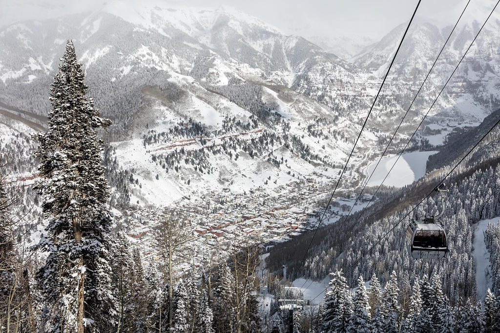 looking down on Telluride, CO with Telluride gondola running in foreground