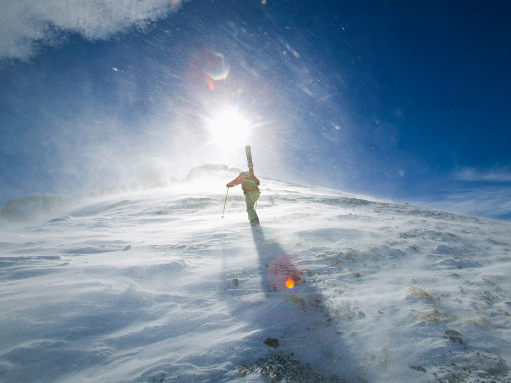 a skier hiking up Palmyra Peak at Telluride