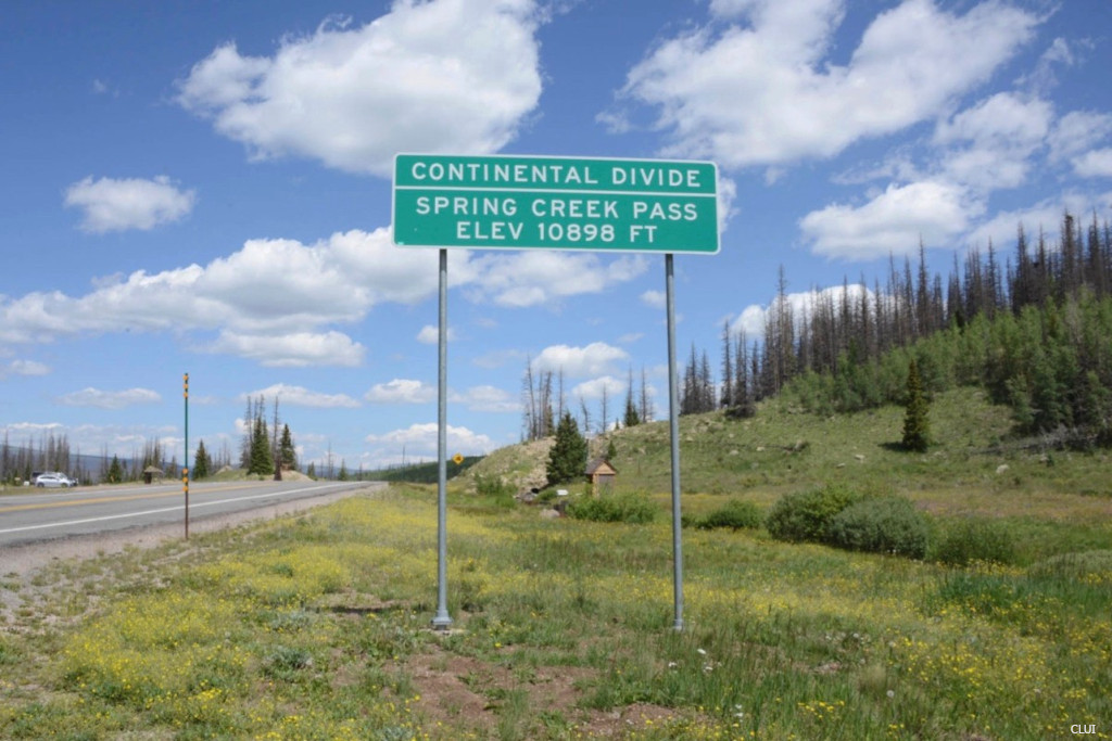 sign and highway on top of Spring Creek Pass on Continental Divide in Colorado