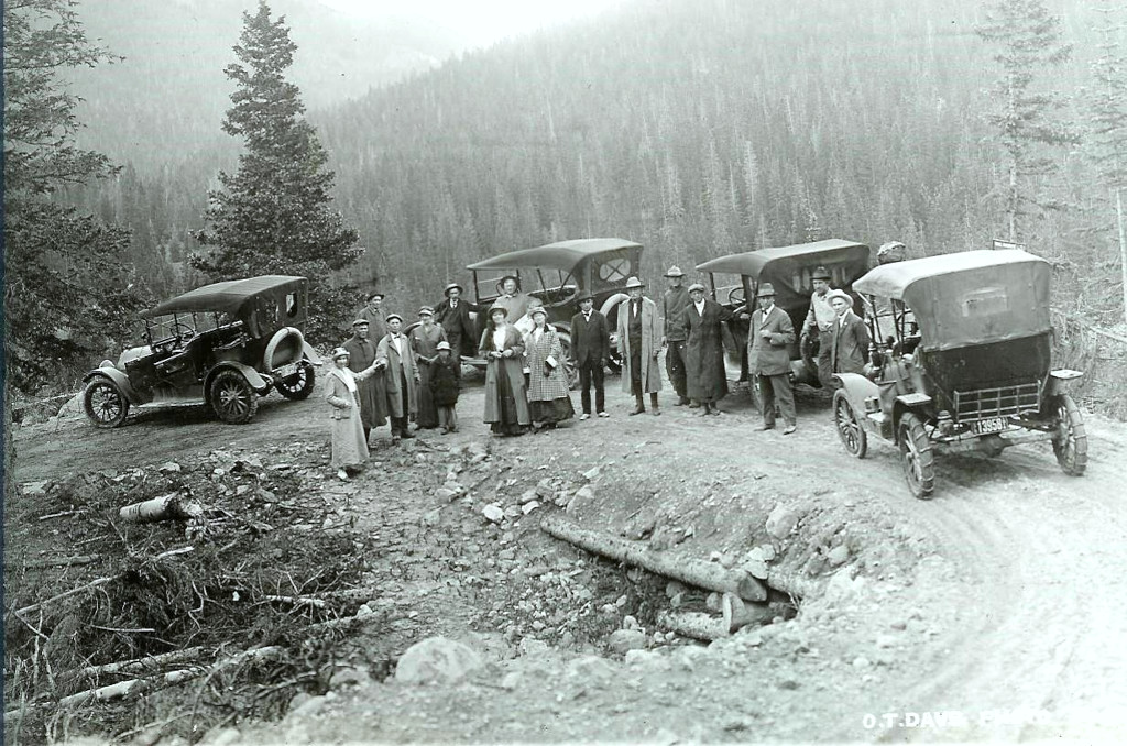 Wolf Creek Pass auto road in 1916 with 3 cars stopped on the mountain
